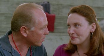 Movie still from “Muriel's Wedding” (1994), directed by P.J. Hogan – An older man and a younger woman are talking to each other; Close Up shot, Over the shoulder angle