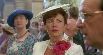 Movie still from “Muriel's Wedding” (1994), directed by P.J. Hogan – A person wearing a hat; Close Up shot, Over the shoulder angle