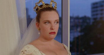 Movie still from “Muriel's Wedding” (1994), directed by P.J. Hogan – A woman wearing a tiara and a white dress; Close Up shot, Over the shoulder angle