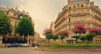 Movie still from “Midnight in Paris” (2011), directed by Woody Allen – A city street with a lot of trees and buildings; Extreme Wide shot, High angle