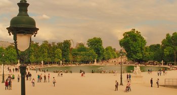 Movie still from “Midnight in Paris” (2011), directed by Woody Allen – A group of people standing around a pond in a park; Extreme Wide shot, High angle