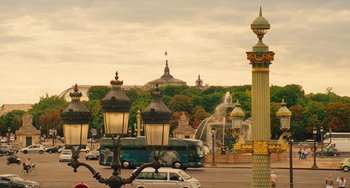 Movie still from “Midnight in Paris” (2011), directed by Woody Allen – A view of a street with a fountain in the background; Extreme Wide shot, Low angle