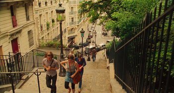 Movie still from “Midnight in Paris” (2011), directed by Woody Allen – A group of people walking down a sidewalk; Extreme Wide shot, High angle