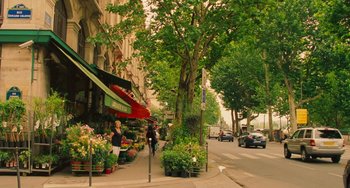 Movie still from “Midnight in Paris” (2011), directed by Woody Allen – A street scene of a tree lined street with people walking on the sidewalk; Extreme Wide shot, High angle