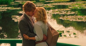 Movie still from “Midnight in Paris” (2011), directed by Woody Allen – A man and a woman kissing in front of a body of water; Medium shot, Over the shoulder angle