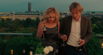 Movie still from “Midnight in Paris” (2011), directed by Woody Allen – A man and a woman standing next to each other holding wine glasses; Medium shot, Over the shoulder angle
