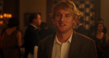 Movie still from “Midnight in Paris” (2011), directed by Woody Allen – A person wearing a suit and tie; Close Up shot, Over the shoulder angle