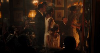 Movie still from “Midnight in Paris” (2011), directed by Woody Allen – A group of people standing in a room; Wide shot, High angle