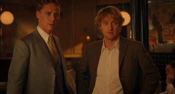 Movie still from “Midnight in Paris” (2011), directed by Woody Allen – A couple of men standing next to each other; Medium shot, Over the shoulder angle