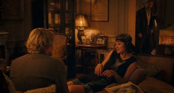 Movie still from “Midnight in Paris” (2011), directed by Woody Allen – Two people sitting on a couch in a living room; Medium shot, Over the shoulder angle