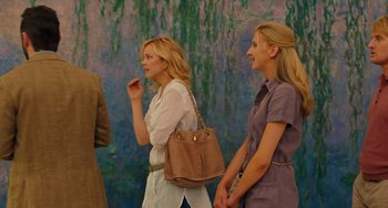 Movie still from “Midnight in Paris” (2011), directed by Woody Allen – Two women are standing next to each other and one is holding a purse; Medium shot, Over the shoulder angle