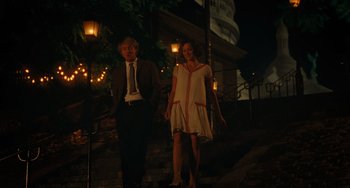 Movie still from “Midnight in Paris” (2011), directed by Woody Allen – A man and a woman walking down the stairs at night; Wide shot, Low angle