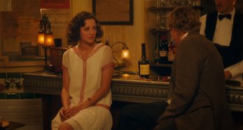 Movie still from “Midnight in Paris” (2011), directed by Woody Allen – A woman sitting on a chair in front of a man; Medium shot, Over the shoulder angle