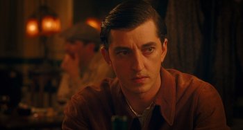 Movie still from “Midnight in Paris” (2011), directed by Woody Allen – A man with a brown shirt is sitting at a table; Close Up shot, Over the shoulder angle