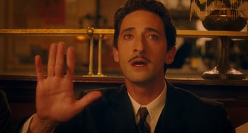 Movie still from “Midnight in Paris” (2011), directed by Woody Allen – A person wearing a suit and tie; Close Up shot, High angle