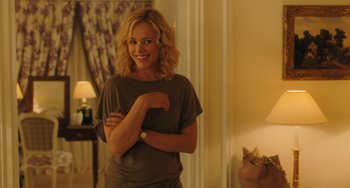 Movie still from “Midnight in Paris” (2011), directed by Woody Allen – A woman standing in front of a mirror with her arms crossed; Medium shot, Over the shoulder angle