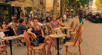 Movie still from “Midnight in Paris” (2011), directed by Woody Allen – A group of people sitting at tables outside; Wide shot, High angle