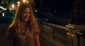 Movie still from “Midnight in Paris” (2011), directed by Woody Allen – A beautiful young lady standing next to a railing at night; Medium shot, Over the shoulder angle