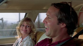 Movie still from “Vacation” (1983), directed by Harold Ramis – A man and a woman sitting in the back of a car; Close Up shot, Over the shoulder angle