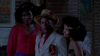 Movie still from “Vacation” (1983), directed by Harold Ramis – A group of people standing next to each other in front of a brick wall; Medium shot, Low angle