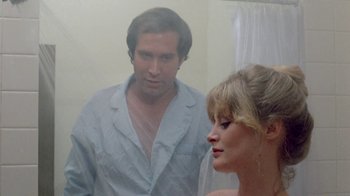 Movie still from “Vacation” (1983), directed by Harold Ramis – A man and a woman looking in a mirror; Close Up shot, Over the shoulder angle