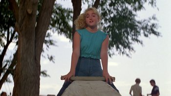Movie still from “Vacation” (1983), directed by Harold Ramis – A woman riding on top of a skateboard on top of a ramp; Medium shot, Low angle