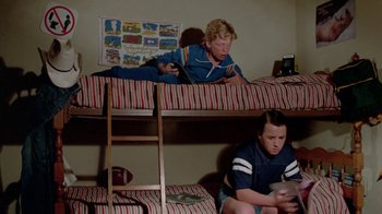 Movie still from “Vacation” (1983), directed by Harold Ramis – A boy and a girl are sitting on top of bunk beds; Medium shot, High angle