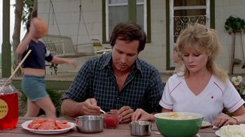 Movie still from “Vacation” (1983), directed by Harold Ramis – A man and a woman sitting at a table with a bowl of food; Medium shot, Over the shoulder angle