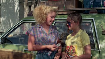 Movie still from “Vacation” (1983), directed by Harold Ramis – Two women are talking and smiling while holding a cigarette; Medium shot, Over the shoulder angle