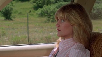 Movie still from “Vacation” (1983), directed by Harold Ramis – A woman sitting in a car looking out the window; Close Up shot, Over the shoulder angle