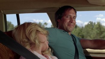 Movie still from “Vacation” (1983), directed by Harold Ramis – A man and a woman sitting in the back seat of a car; Close Up shot, Low angle