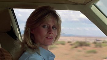 Movie still from “Vacation” (1983), directed by Harold Ramis – A woman standing in a vehicle looking out the window; Close Up shot, Low angle