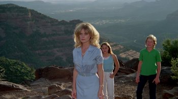 Movie still from “Vacation” (1983), directed by Harold Ramis – A woman standing on top of a mountain next to another woman; Medium shot, Low angle