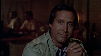 Movie still from “Vacation” (1983), directed by Harold Ramis – A person wearing a jacket and tie; Close Up shot, Over the shoulder angle