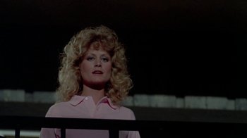 Movie still from “Vacation” (1983), directed by Harold Ramis – A woman in a pink shirt is standing in front of a railing; Close Up shot, Low angle