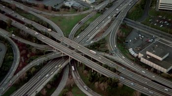 Movie still from “Vacation” (1983), directed by Harold Ramis – An aerial view of an intersection with a lot of traffic; Extreme Wide shot, Overhead angle