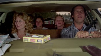 Movie still from “Vacation” (1983), directed by Harold Ramis – A group of people sitting in the back of a car; Medium shot, Low angle