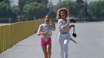 Movie still from “Vacation” (1983), directed by Harold Ramis – A woman and a young girl walking down a sidewalk; Wide shot, Low angle