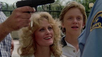 Movie still from “Vacation” (1983), directed by Harold Ramis – Two people blow drying each other's hair outside; Close Up shot, Over the shoulder angle