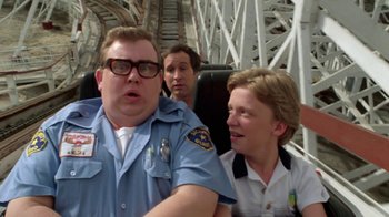 Movie still from “Vacation” (1983), directed by Harold Ramis – A group of people sitting on top of a roller coaster; Medium shot, Over the shoulder angle