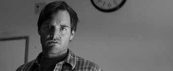 Movie still from “Nebraska” (2013), directed by Alexander Payne – Black and white photograph of a man in front of a clock; Close Up shot, Low angle