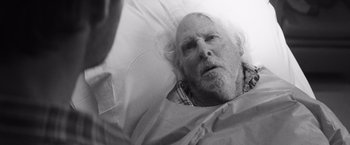 Movie still from “Nebraska” (2013), directed by Alexander Payne – An older man laying in a hospital bed; Close Up shot, Over the shoulder angle