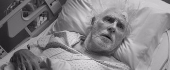 Movie still from “Nebraska” (2013), directed by Alexander Payne – An older man laying in a hospital bed; Close Up shot, Overhead angle