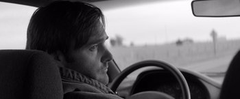 Movie still from “Nebraska” (2013), directed by Alexander Payne – Black and white photograph of a man in the driver's seat of a car; Close Up shot, Low angle