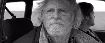 Movie still from “Nebraska” (2013), directed by Alexander Payne – An older man with a beard and glasses; Close Up shot, Over the shoulder angle