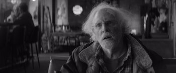 Movie still from “Nebraska” (2013), directed by Alexander Payne – An old man with a white beard looking at the camera; Close Up shot, Over the shoulder angle