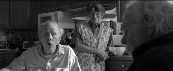 Movie still from “Nebraska” (2013), directed by Alexander Payne – An older woman and a younger man in a kitchen; Medium shot, Over the shoulder angle