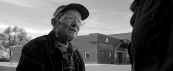 Movie still from “Nebraska” (2013), directed by Alexander Payne – An older man wearing glasses and a hat; Close Up shot, Low angle