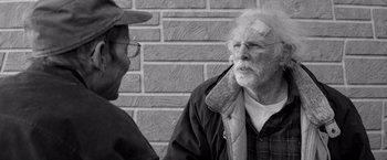 Movie still from “Nebraska” (2013), directed by Alexander Payne – A man with bandages on his head talking to another man; Close Up shot, Over the shoulder angle