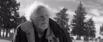 Movie still from “Nebraska” (2013), directed by Alexander Payne – An old man with a white beard and glasses looking to his left; Close Up shot, Over the shoulder angle